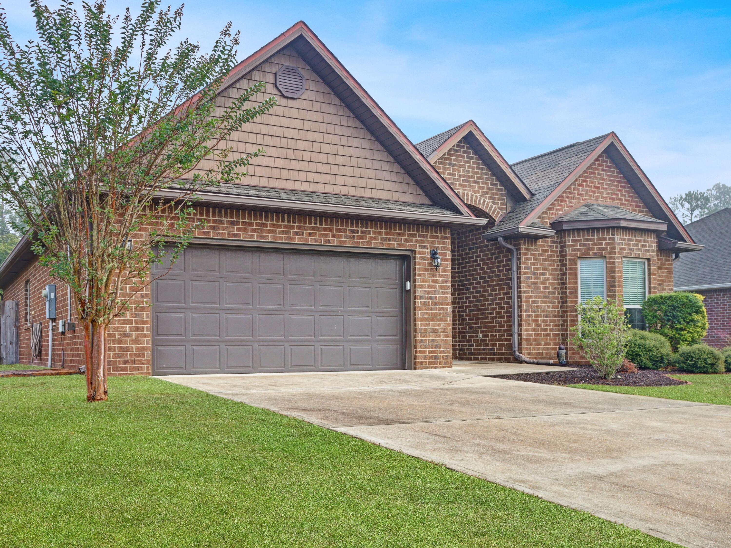 4753 Dupont Circle Pace, FL 32571 - Photo 5 of 42 a front view of a house with a garden