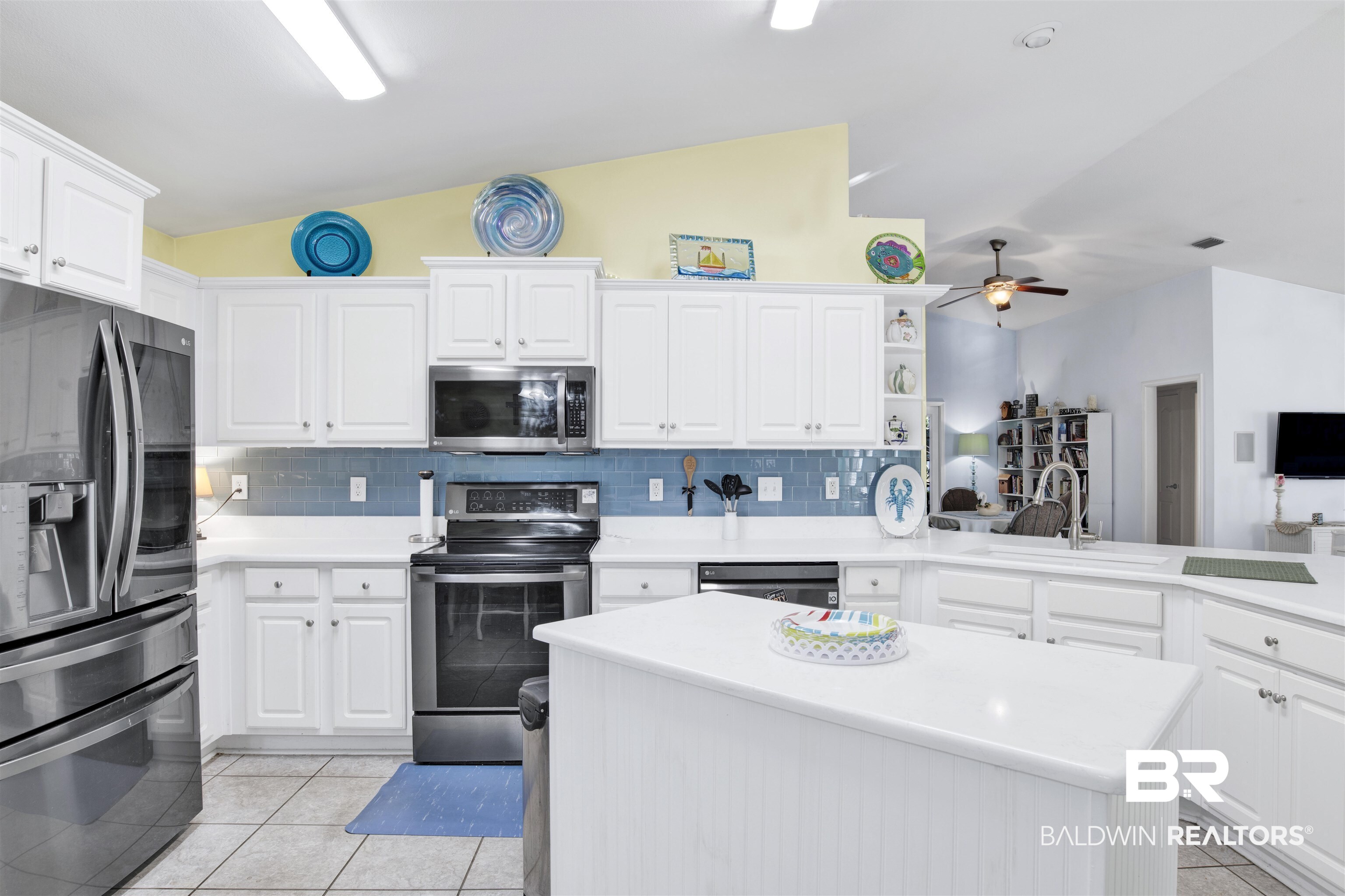 314 Blackfriars Street Fairhope, AL 36532 - Photo 6 of 25 Kitchen with tasteful backsplash, white cabinetry, vaulted ceiling, and appliances with stainless steel finishes
