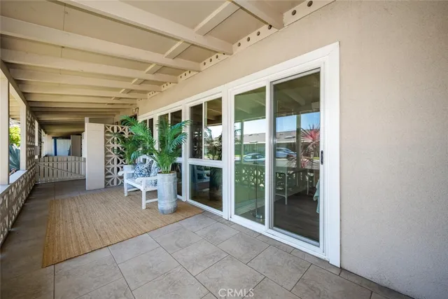 a view of a patio with a table and chairs and potted plants