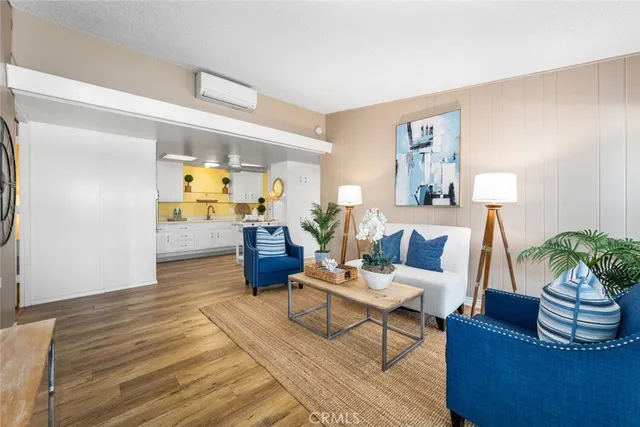a living room with furniture and kitchen view