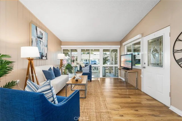 a living room with furniture and a wooden floor