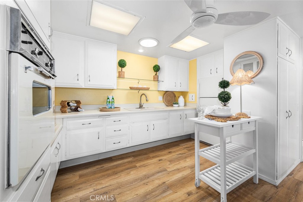 1121 Northwood Road, Unit 237D M9 Seal Beach, CA 90740 - Photo 22 of 45 a kitchen with a sink cabinets and window