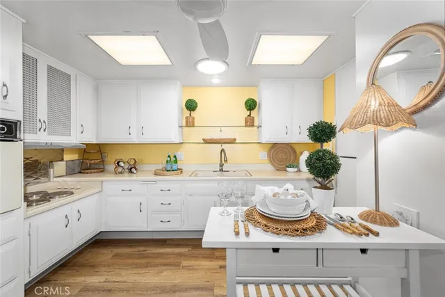 a kitchen with stainless steel appliances kitchen island granite countertop a sink and a stove