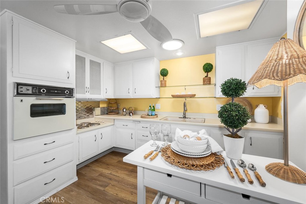 1121 Northwood Road, Unit 237D M9 Seal Beach, CA 90740 - Photo 24 of 45 a kitchen with stainless steel appliances kitchen island granite countertop a sink and a stove