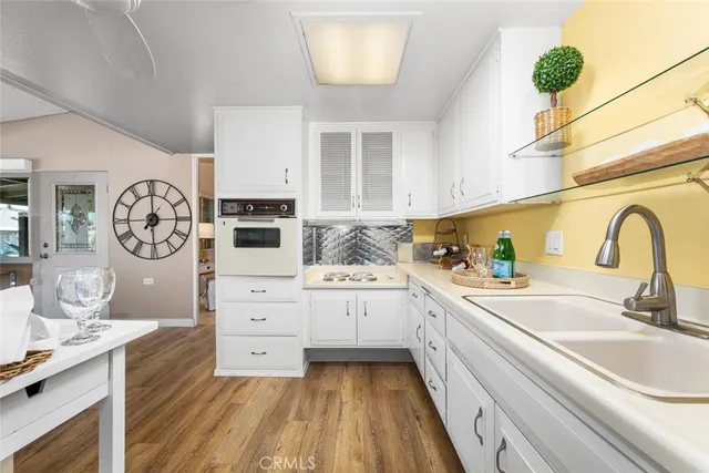 a spacious bedroom with a bed and a lamp