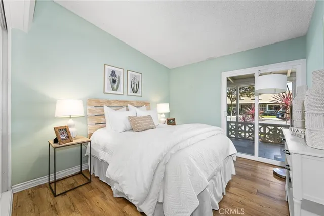 a bedroom with a bed and a lamp on table