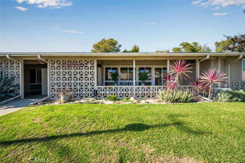 1121 Northwood Road, Unit 237D M9 Seal Beach, CA 90740 - Photo 5 of 45 a front view of a house with a yard