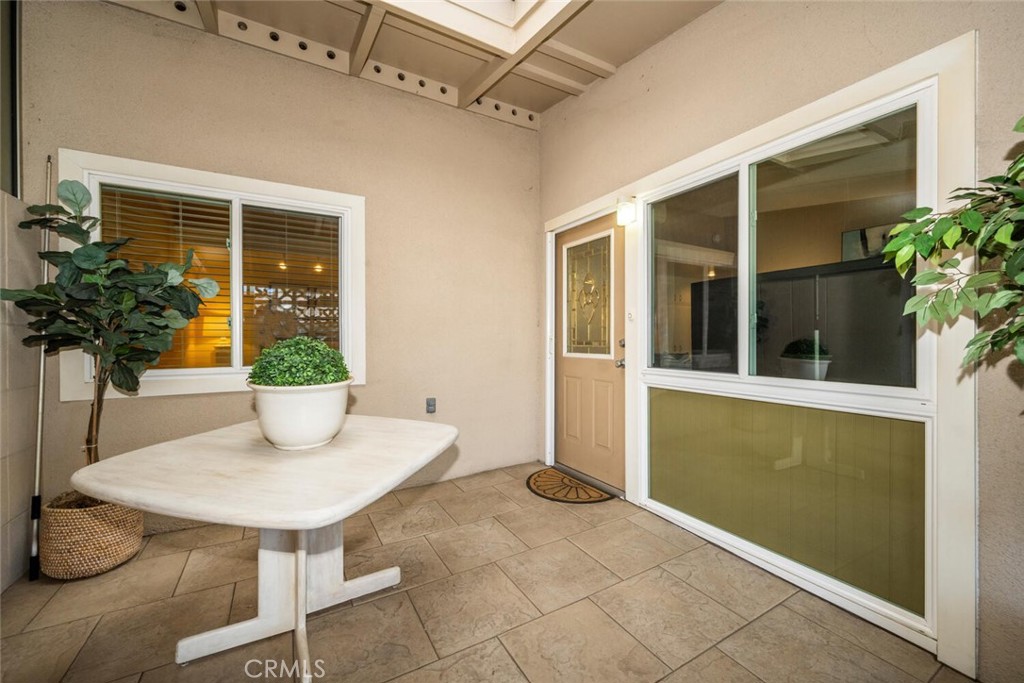 1121 Northwood Road, Unit 237D M9 Seal Beach, CA 90740 - Photo 8 of 45 a view of a porch with a table and chairs