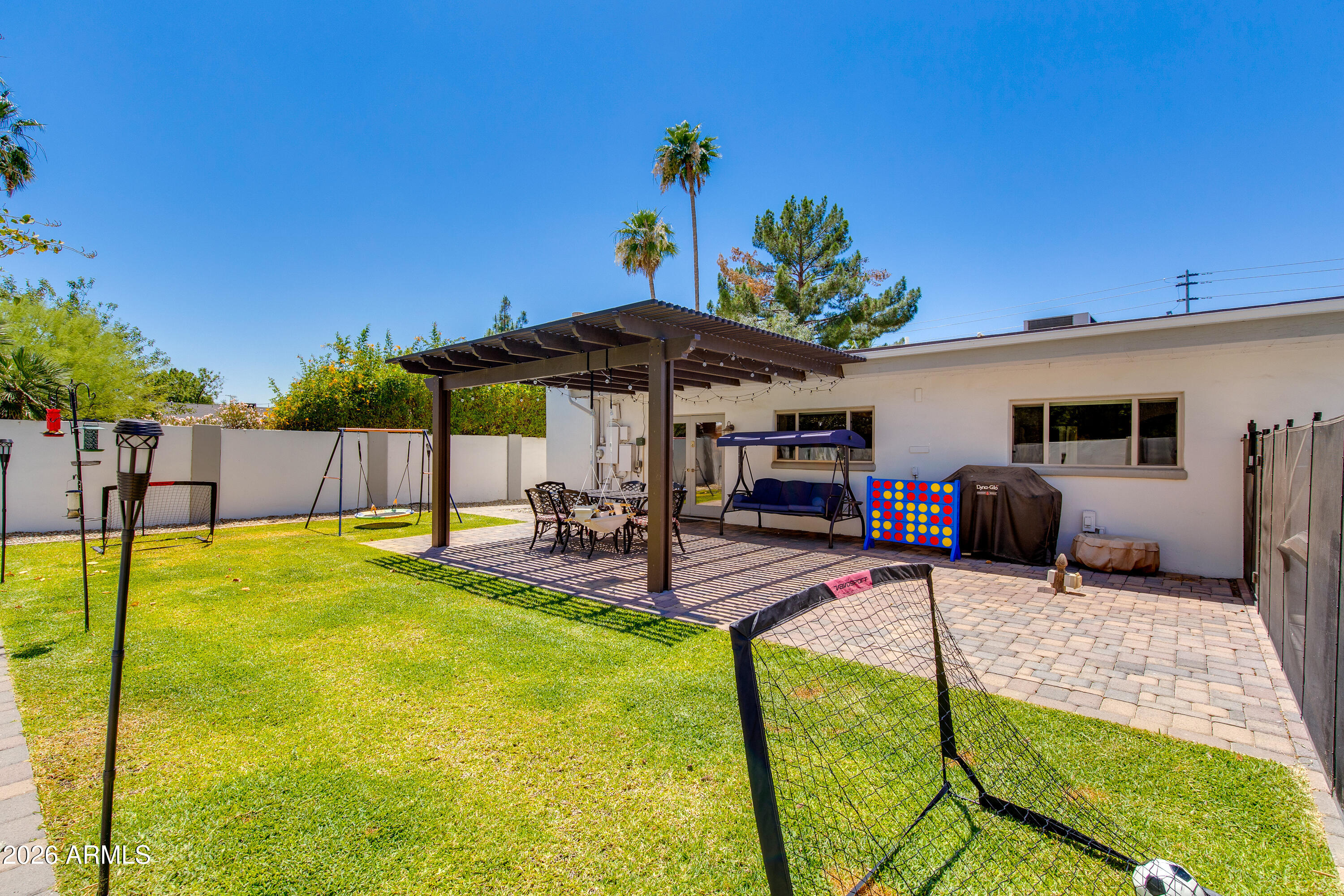8219 North 3rd Avenue Phoenix, AZ 85021 - Photo 45 of 52 a view of a backyard with table and chairs under an umbrella