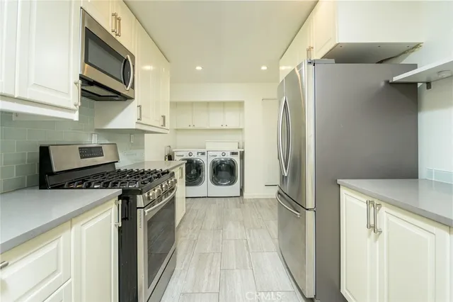 a kitchen with stainless steel appliances a refrigerator stove and sink