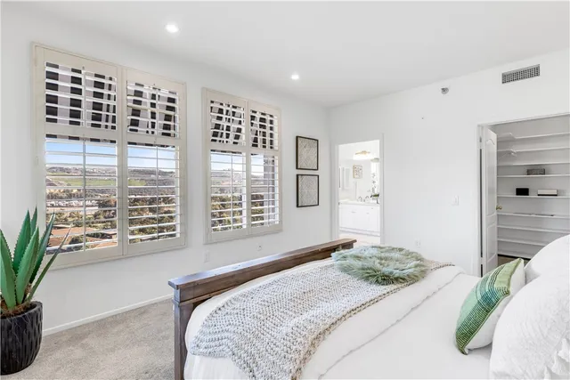 a bedroom with a large bed and a window