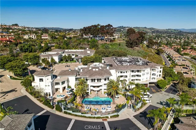 an aerial view of a residential houses with yard