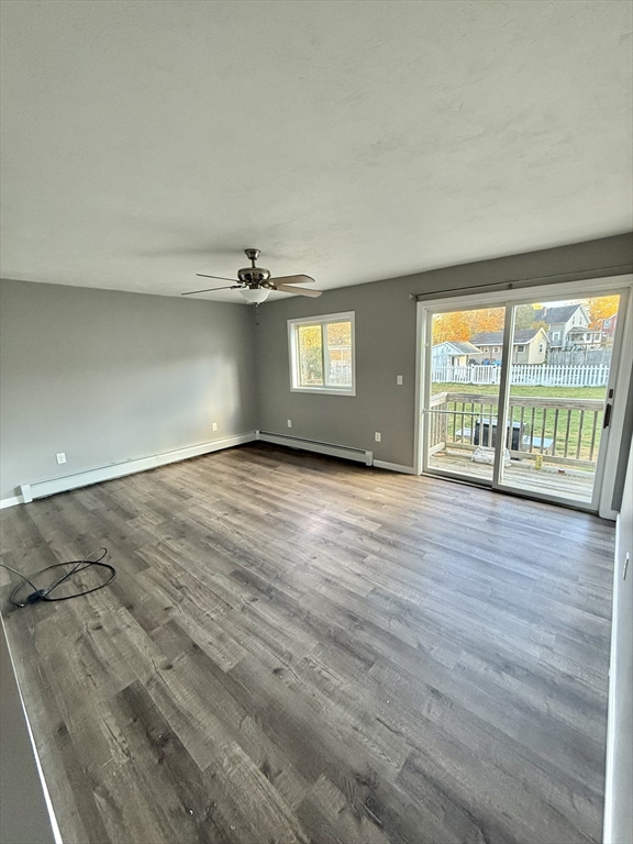 6 Canal Street, Unit B Sutton, MA 01590 - Photo 3 of 15 an empty room with wooden floor and windows