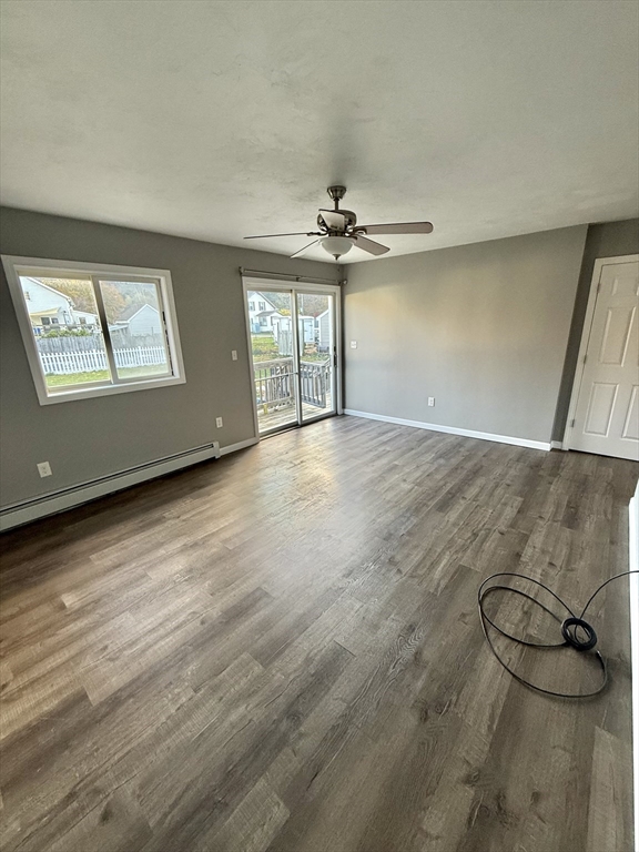 6 Canal Street, Unit B Sutton, MA 01590 - Photo 4 of 15 wooden floor in an empty room with a window