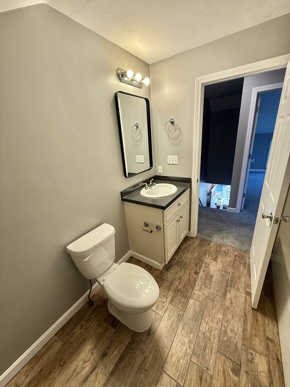6 Canal Street, Unit B Sutton, MA 01590 - Photo 6 of 15 a bathroom with a toilet sink and mirror