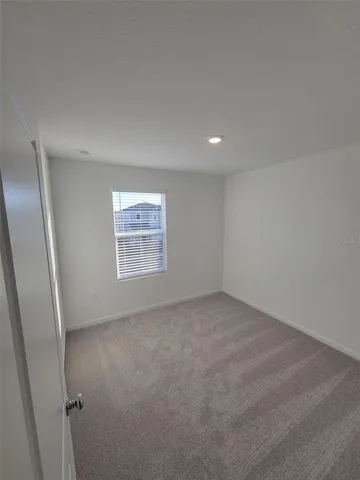 an empty room with a empty space and window