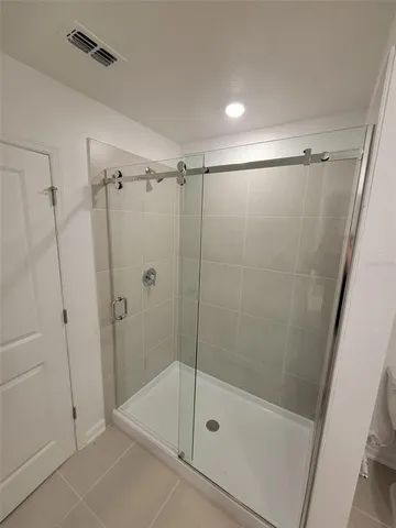 a bathroom with a shower and a bath tub