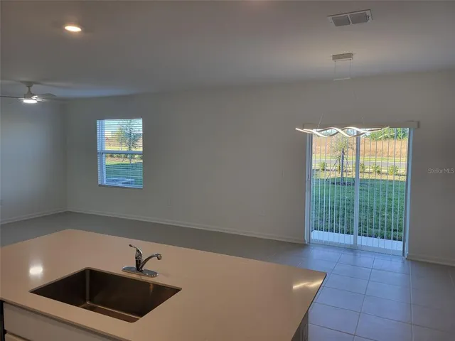 a view of a kitchen with a sink dishwasher and a microwave