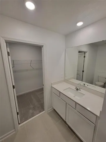 a bathroom with a sink a mirror and a shower