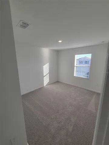 a view of a big room with window and stairs