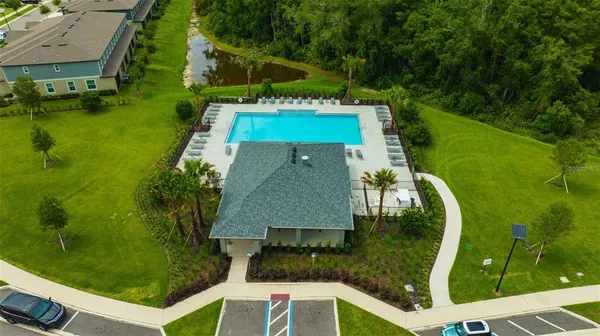 a aerial view of a house with swimming pool garden and patio