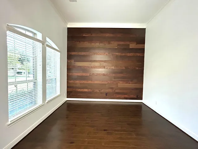 a view of wooden floor and window in a room