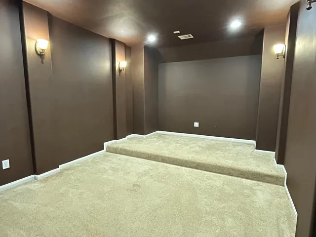 an empty room with wooden floor and window