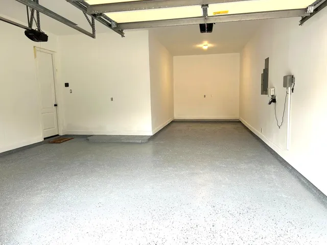 a picture of a rug with a white wall and a painting on the wall