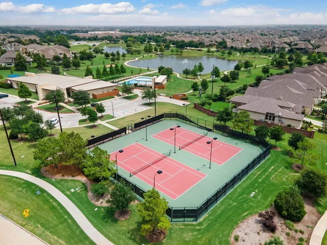 an aerial view of a house with pool lake view and mountain view