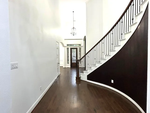 a view of entryway and hall with wooden floor