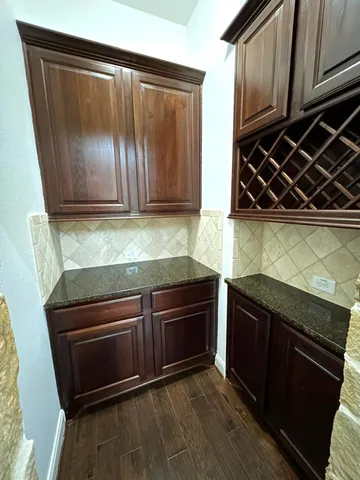 a kitchen with wooden cabinets and a stove top oven