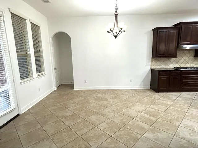 a view of a kitchen with granite countertop cabinets and stainless steel appliances