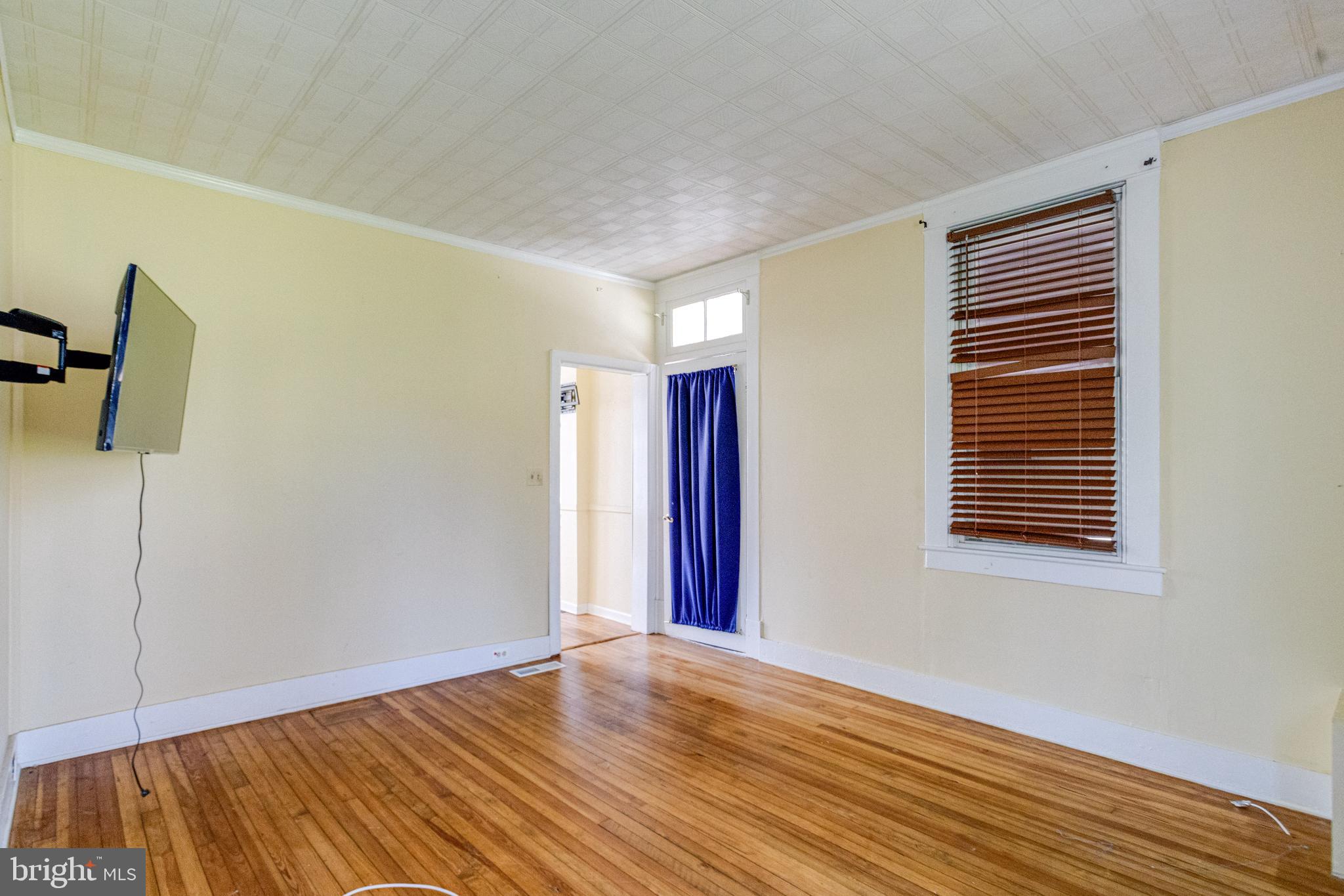 8421 Old Harford Road Parkville, MD 21234 - Photo 11 of 44 a view of an empty room with wooden floor and a window