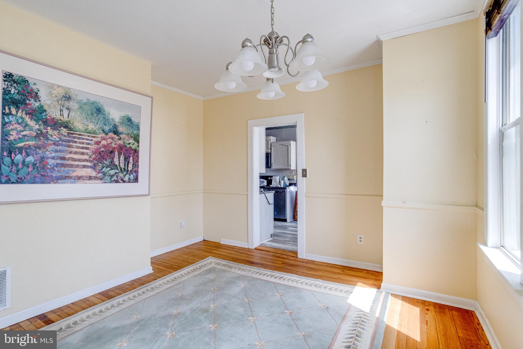 8421 Old Harford Road Parkville, MD 21234 - Photo 15 of 44 a bedroom with a bed and a chandelier