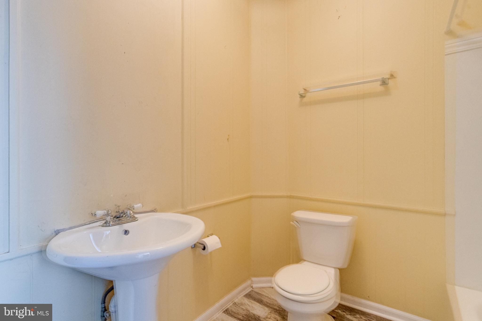 8421 Old Harford Road Parkville, MD 21234 - Photo 19 of 44 a bathroom with a sink a toilet and mirror