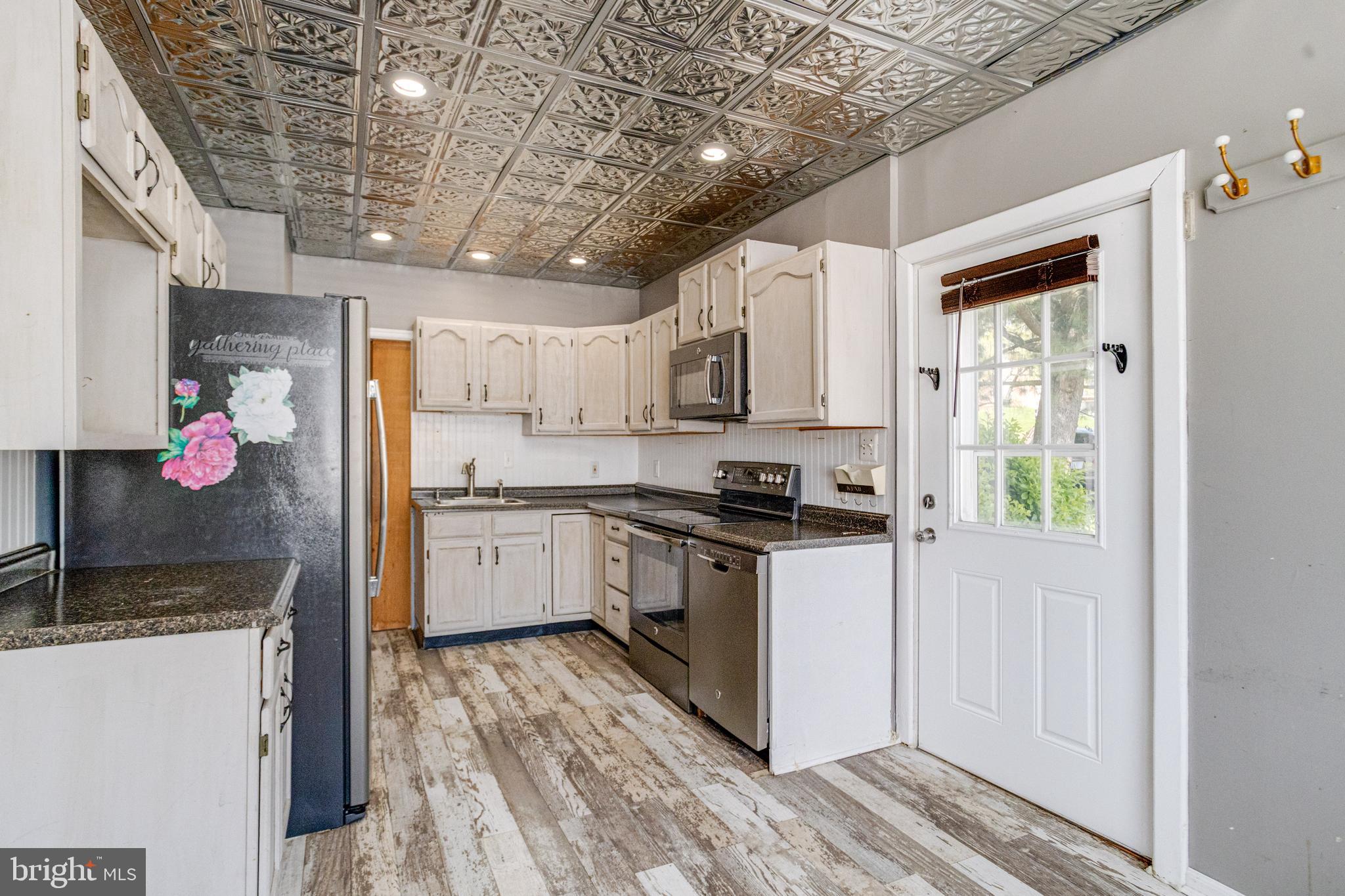 8421 Old Harford Road Parkville, MD 21234 - Photo 22 of 44 a kitchen with stainless steel appliances granite countertop a sink stove and refrigerator