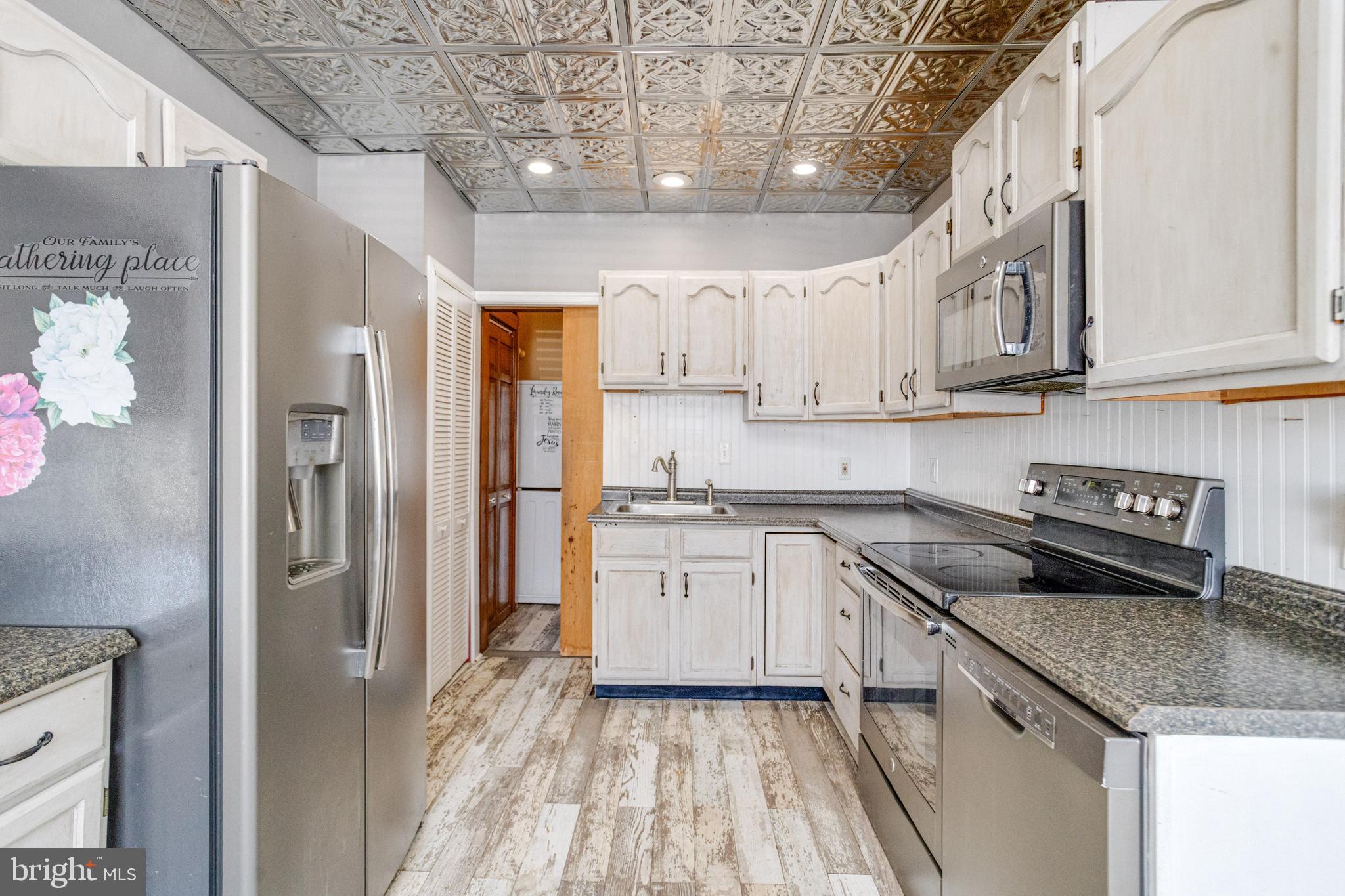 8421 Old Harford Road Parkville, MD 21234 - Photo 25 of 44 a kitchen with stainless steel appliances granite countertop a sink and cabinets