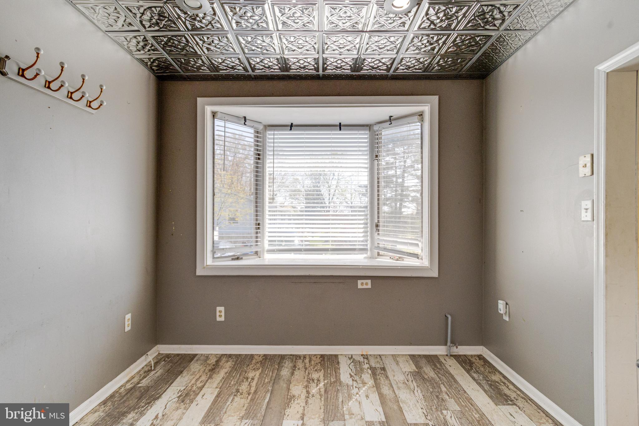 8421 Old Harford Road Parkville, MD 21234 - Photo 27 of 44 a view of an empty room with wooden floor and a window