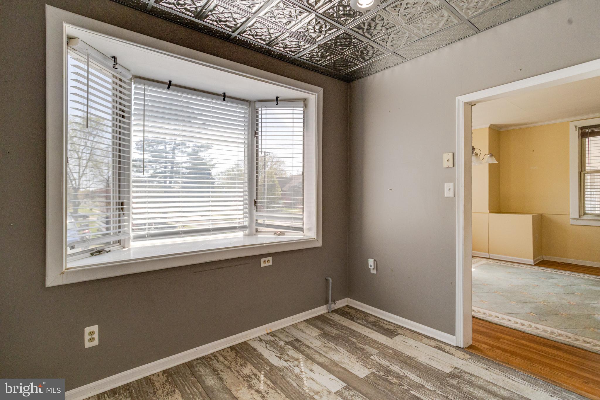 8421 Old Harford Road Parkville, MD 21234 - Photo 28 of 44 a view of an empty room with wooden floor and a window