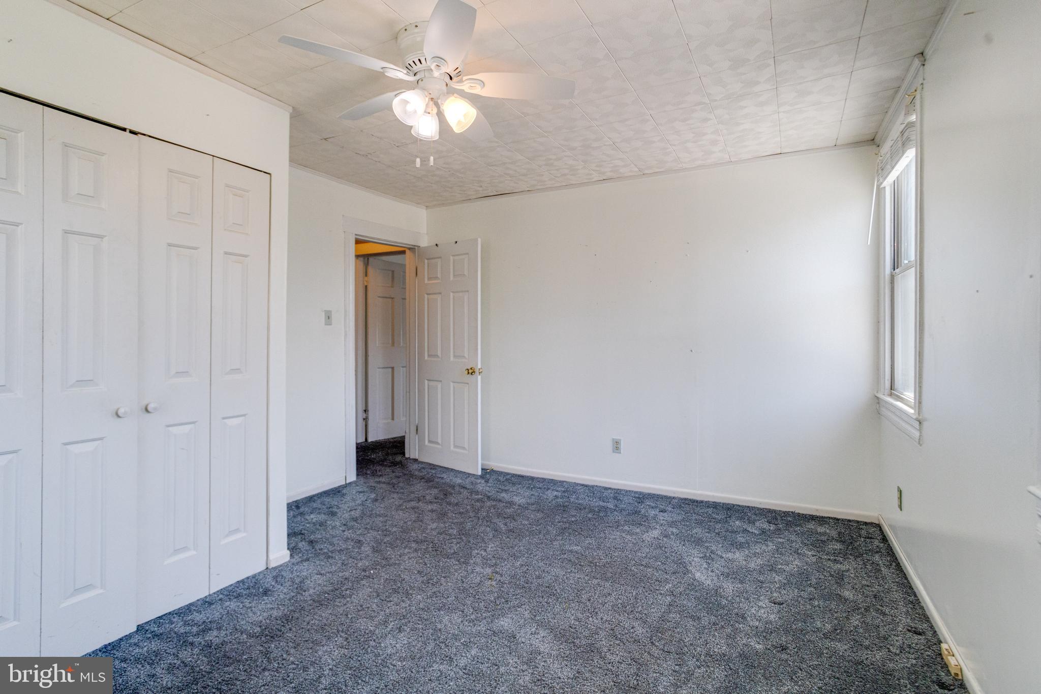 8421 Old Harford Road Parkville, MD 21234 - Photo 32 of 44 an empty room with a ceiling fan and a window