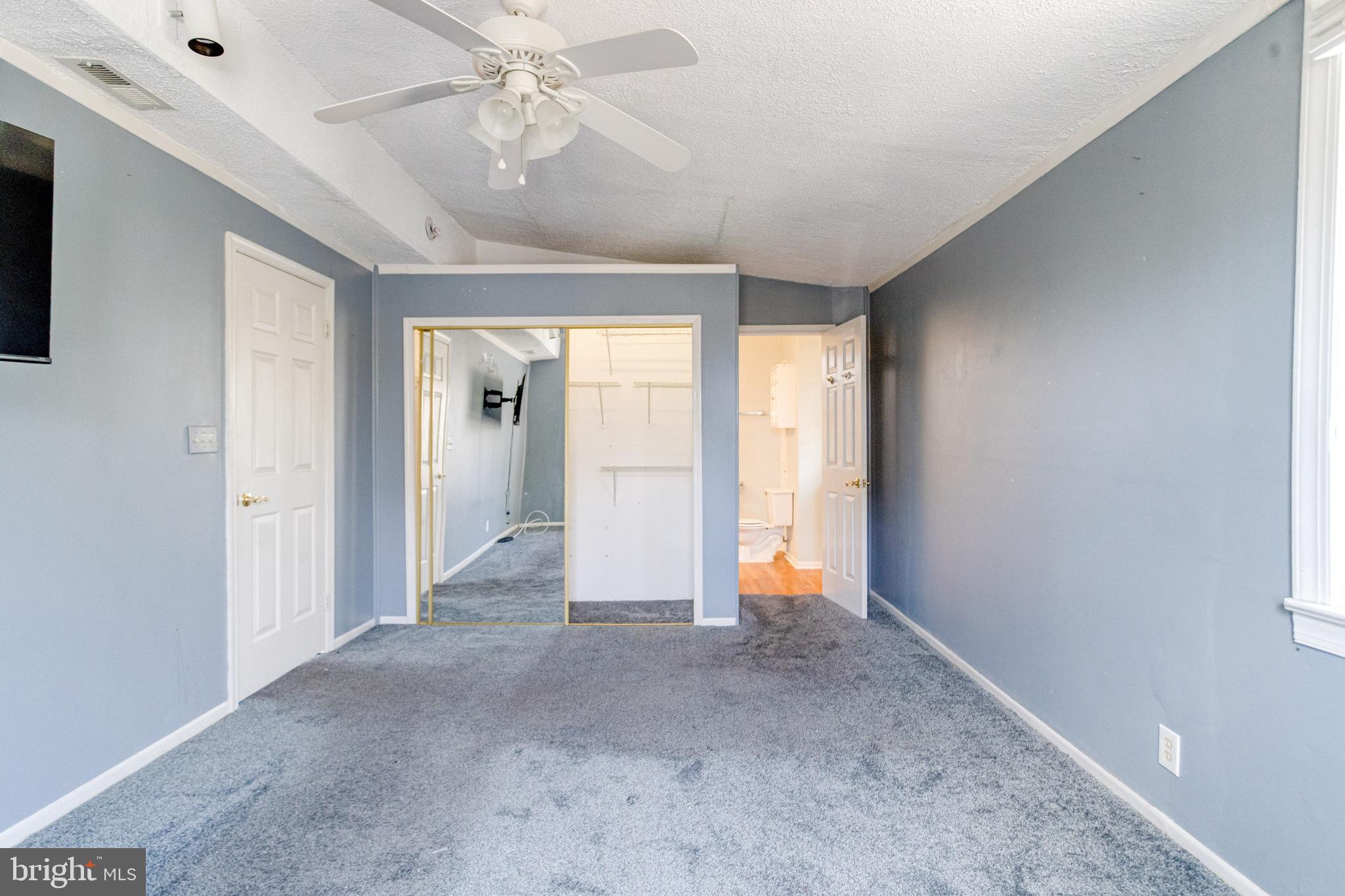 8421 Old Harford Road Parkville, MD 21234 - Photo 39 of 44 a view of a big room with windows and chandelier fan