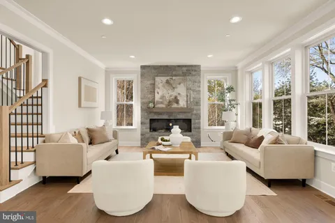 a living room with fireplace furniture and a large window
