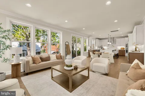 a kitchen with kitchen island granite countertop a stove a sink a center island and a window