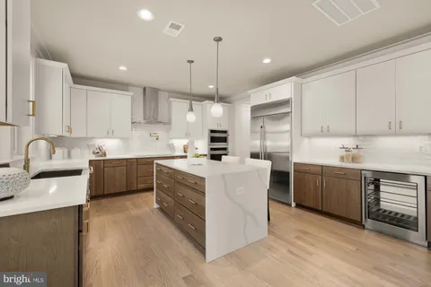 a large kitchen with a table and chairs