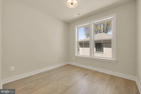 a bathroom with a shower sink vanity mirror and toilet