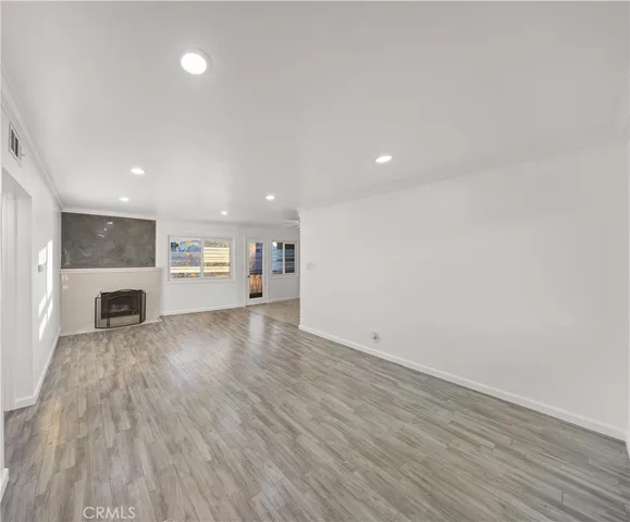 a view of kitchen and hall with wooden floor