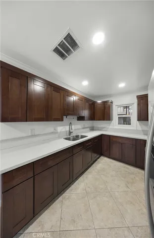 a large kitchen with lots of counter space and a sink