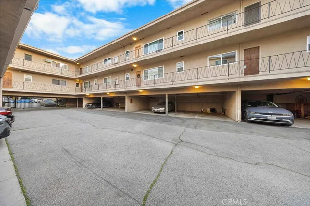 a front view of building with cars