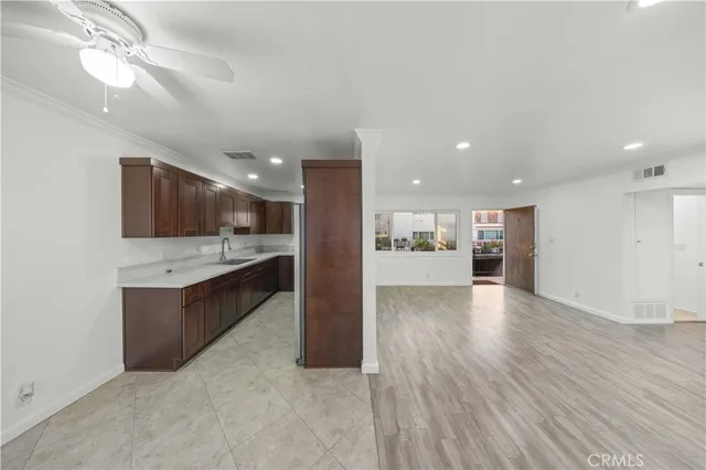 a view of kitchen with kitchen island and stainless steel appliances