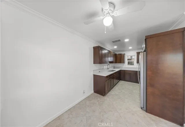 a large kitchen with a refrigerator and a sink